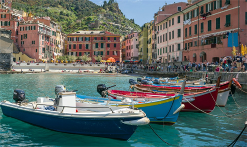 Colorful fishing boats in the harbor of a picturesque Italian coastal village