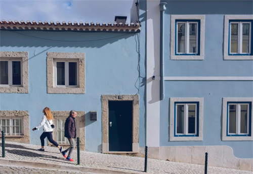 People working in Portugal are walking on the street.